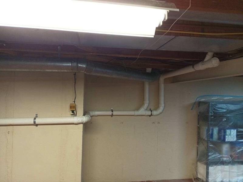 Basement plumbing for house with damaged pipes under floor